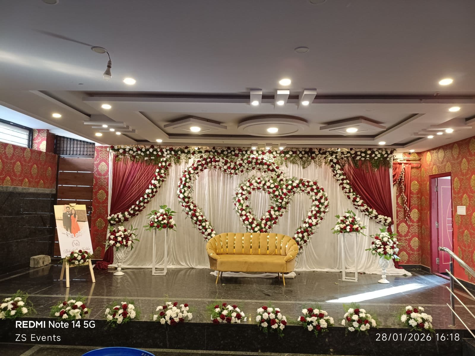 Double heart floral backdrop on a banquet stage with rose borders