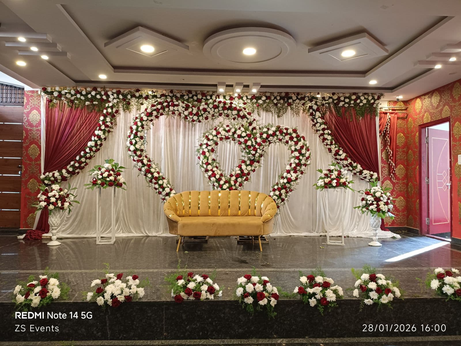 Wide view of a double heart floral engagement stage