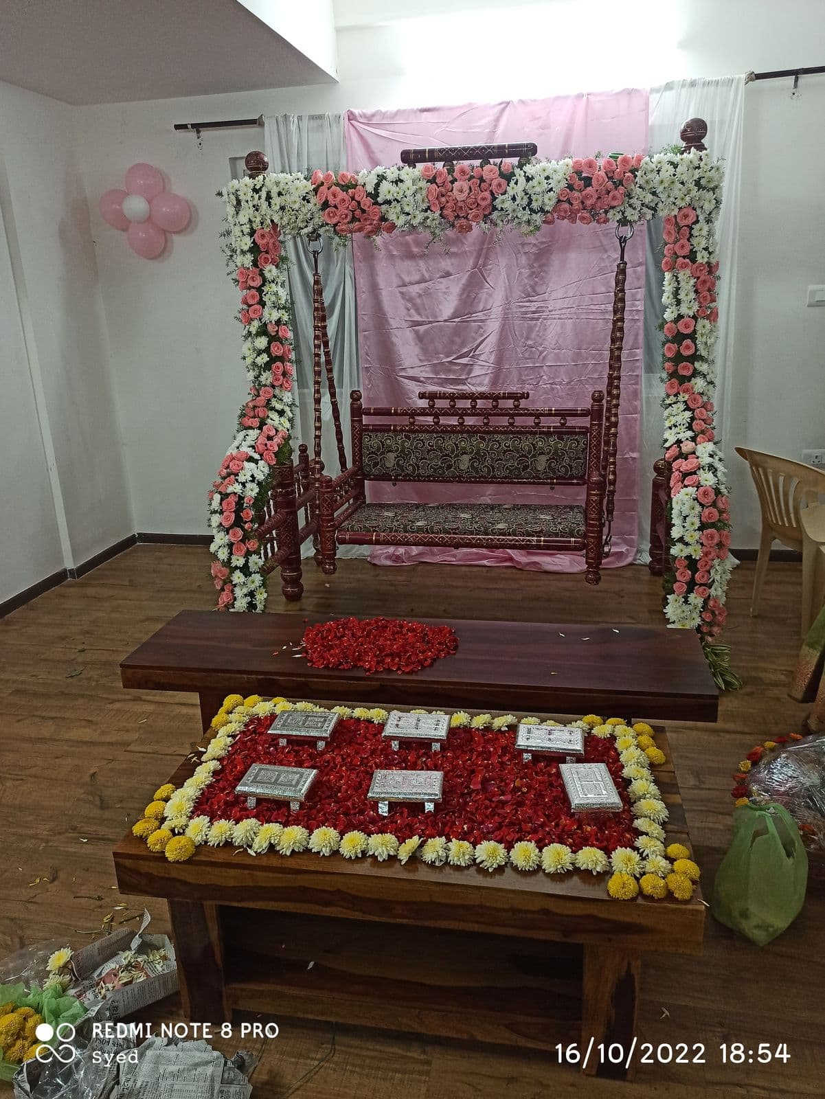 Floral jhoola swing for a baby shower ceremony