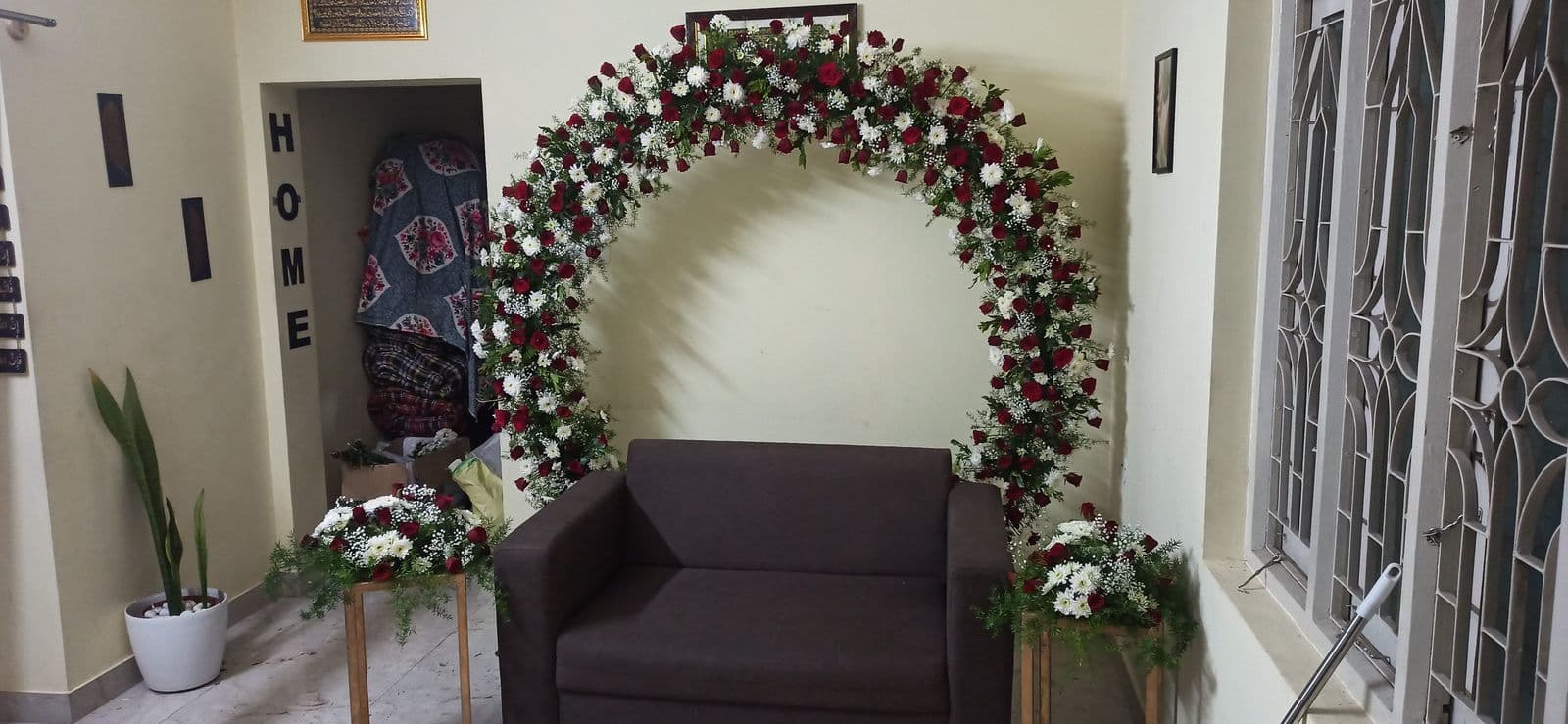 Mixed rose floral ring arch set up in a living room