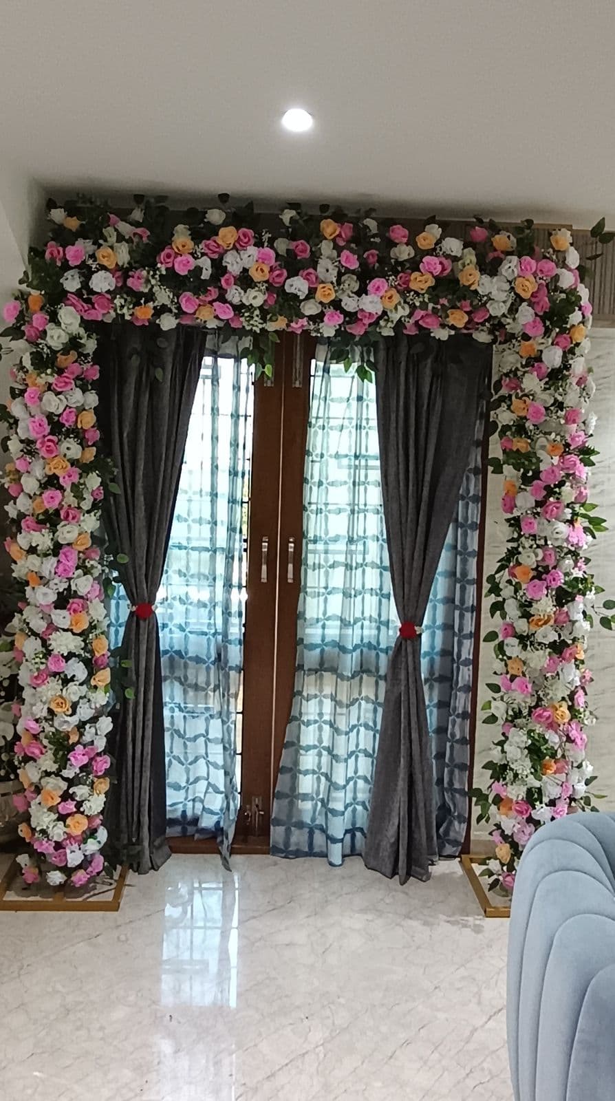French doors framed with pink, white and red roses