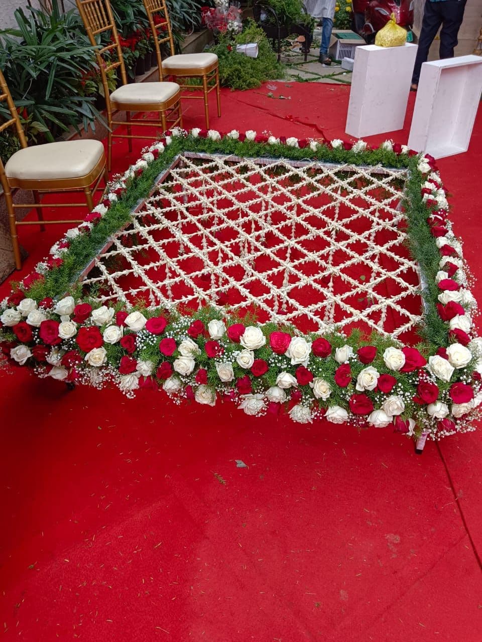 Red and white rose phoolon ki chadar on a red carpet