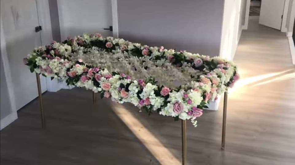 White rose phoolon ki chadar laid out before a bridal entry